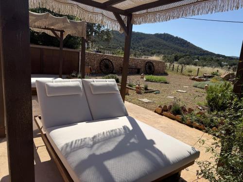 a chaise lounger on a patio with a view at Agroturismo Sa Marina - Adults Only in Cala Boix