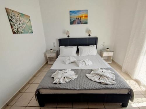 a bedroom with a bed with towels on it at ARTEMIS beach studios in Kalamaki Heraklion