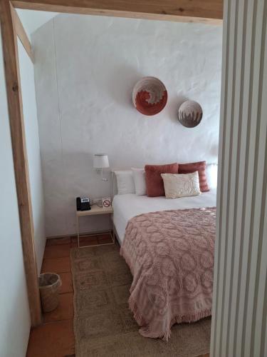 a bedroom with a bed and two plates on the wall at Umoya Residence in Cape Town