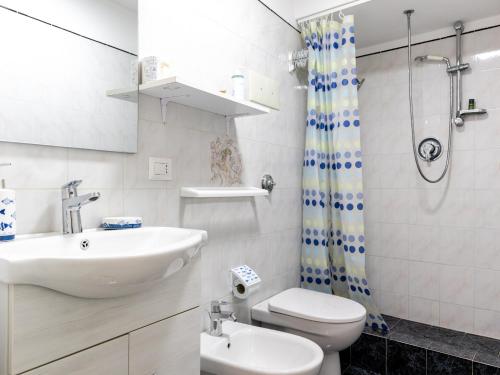 a bathroom with a sink and a toilet and a shower at Mediterranean dream - Caminia Bay in Stalettì