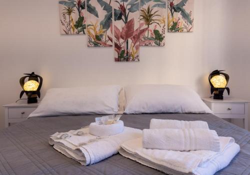 a bedroom with towels and two lamps on a bed at Mediterranean dream - Caminia Bay in Stalettì