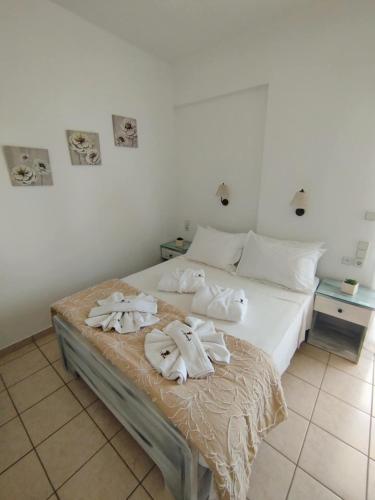 a bedroom with a bed with towels on it at ARTEMIS beach studios in Kalamaki Heraklion