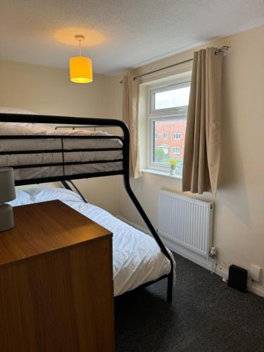 a bedroom with a bunk bed and a window at Quiet, Sleeps 12, 2 bathrooms, Lots of parking, KIA 2 in Nottingham