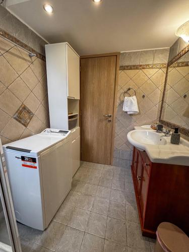 a bathroom with a sink and a counter and a mirror at Gabi's Nest in Chalkida