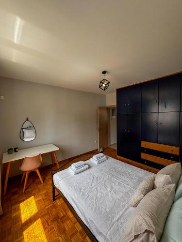 a bedroom with a bed and a table and a couch at Gabi's Nest in Chalkida