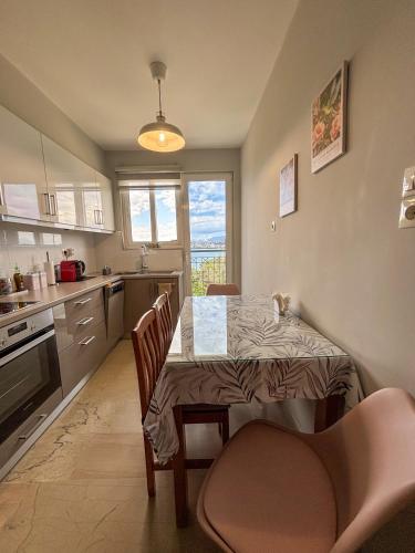 a kitchen with a table and chairs and a dining room at Gabi's Nest in Chalkida