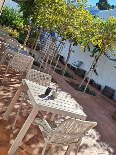 a white picnic table and chairs on a patio at Umoya Residence in Cape Town