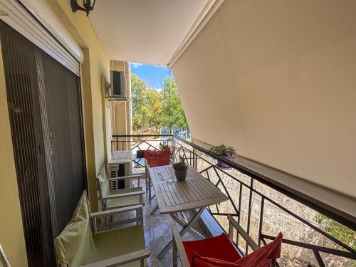 a balcony with a table and chairs on a building at Gabi's Nest in Chalkida