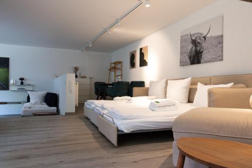 a bedroom with a bed and a table and a couch at Retro-Urban in der Bregenzer Fussgängerzone in Bregenz