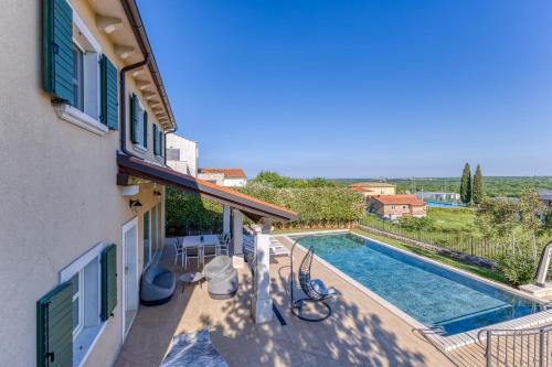 a villa with a swimming pool and a house at Villa Sana in Selina