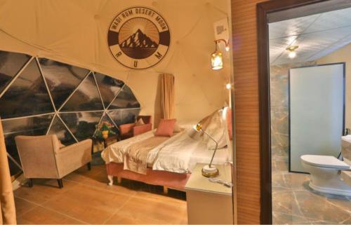 a hotel room with a bed and a chair at WADI RUM DESERt MOON in Wadi Rum