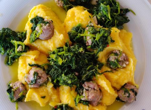 a white plate of food with broccoli and meat at Albergo Conte Max in Capracotta