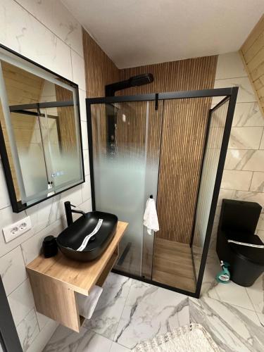 a bathroom with a black sink and a shower at A Frame Bâlea Chalet in Cîrţişoara