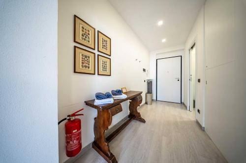 a hallway with a wooden table and a fire extinguisher at Romantic Laghée in Bellano