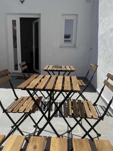 a group of tables and chairs in a room at 5Melros in Santiago do Cacém