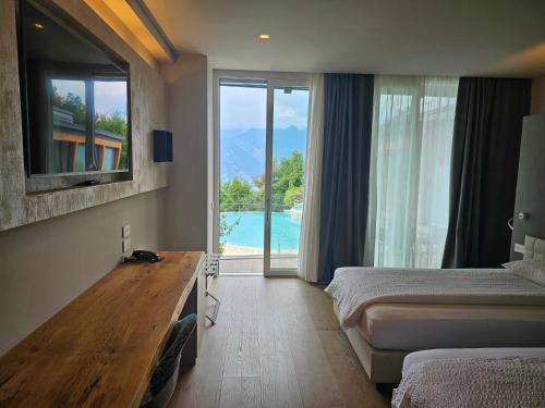a hotel room with two beds and a view of a pool at Locanda Monte Baldo in Malcesine