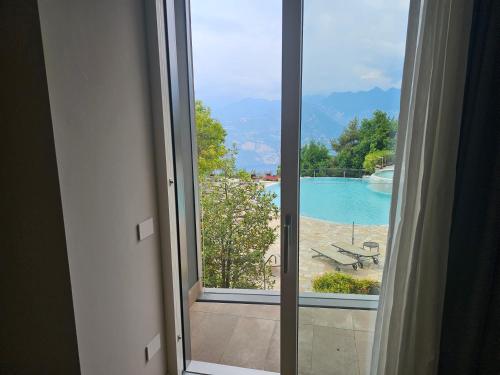 a window with a view of a swimming pool at Locanda Monte Baldo in Malcesine