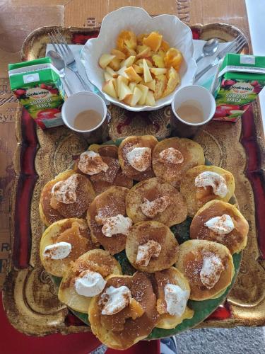 a table with a tray of donuts and a plate of fries at The Vie Llage - Authorial Suites Bungalows in Vagos
