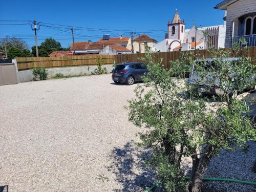 a car parked in a driveway next to a fence at The Vie Llage - Authorial Suites Bungalows in Vagos