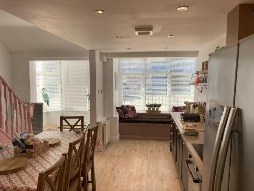 a kitchen with a counter and a table and chairs at Blacksands Seaview Cottage, Aberdour in Aberdour