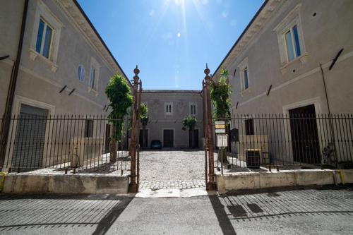 an entrance to a building with an iron gate at Gli Ippocastani - Free Parking - Old Town - Elegant & Spacious in LʼAquila