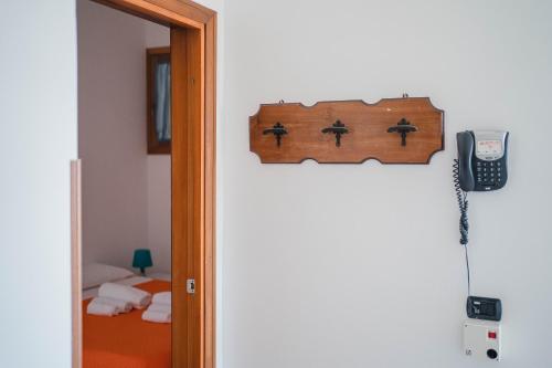 a door to a room with a phone and a bed at Residence Riviera in Palinuro