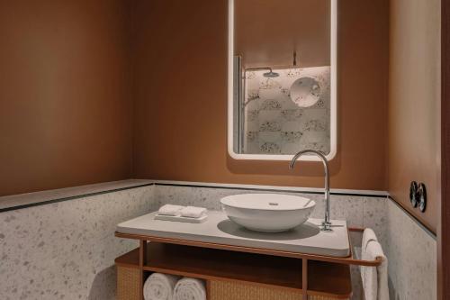 a bathroom with a bowl sink on a table at Sheraton Stockholm Hotel in Stockholm