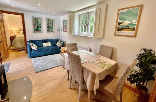 a living room with a table and chairs and a couch at The Stables at The Forge Self Contained Apartment in Pyecombe