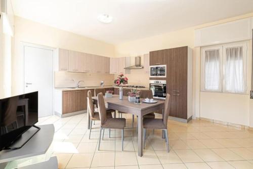 a kitchen and dining room with a table and chairs at Bellezza In Cilento Panoramic Apts in Castellabate