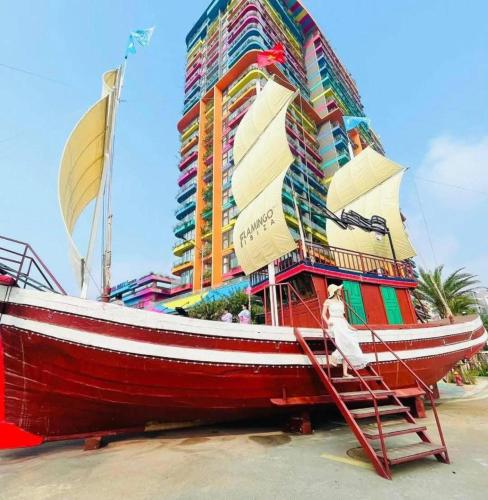 a boat on display in front of a building at Flamingo Hải Tiến Tầng 15 View Hướng Biển, Cực Chill in Thanh Hóa