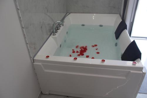 a white bath tub with blood in it at Encanto Suites by La Sirenetta in Taormina