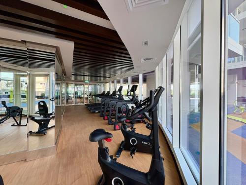 a gym with a row of exercise bikes in it at Dubai Studio Retreat Pool, Gym, Balcony & Queen Bed for Two in Dubai