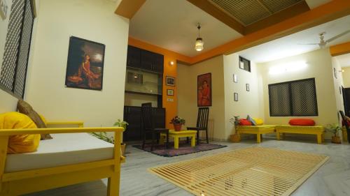a living room with a bed and a table and chairs at hotel kishangarh jaisalmer in Jaisalmer