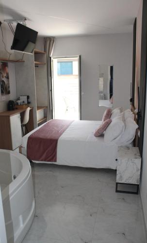 a bedroom with a bed and a bath tub and a tub at Encanto Suites by La Sirenetta in Taormina