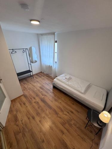 a small room with a bed and a table in it at Bavaria Home Apartments in Rohrbach