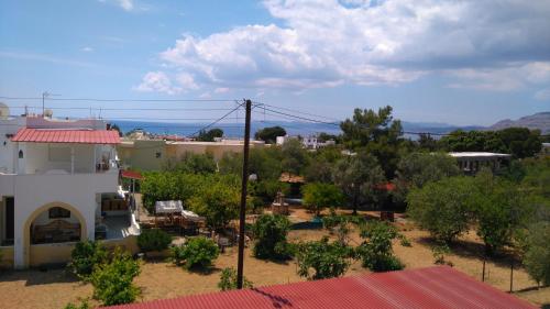 a view of a town with a building and trees at Maria Apartments in Pefki Rhodes