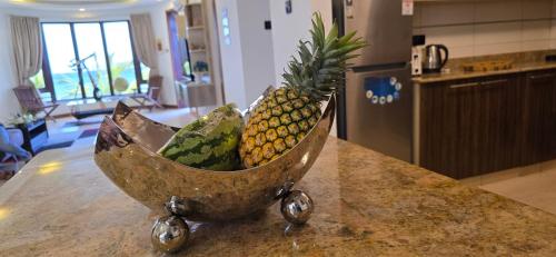a bowl of fruit sitting on top of a counter at English Point Residence Beach Apartments Mombasa in Mombasa