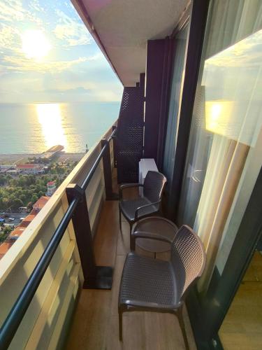 a balcony of a cruise ship with chairs and the ocean at Апартаменты Батуми первая линия in Batumi