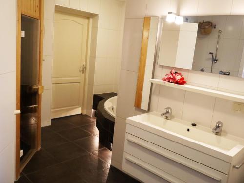 a bathroom with a sink and a toilet at Luxe vakantiehuis in Friesland in Joure