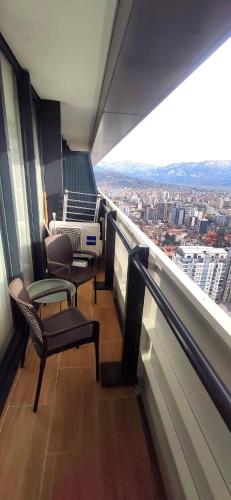 a balcony with two chairs and a view of a city at Апартаменты Батуми первая линия in Batumi
