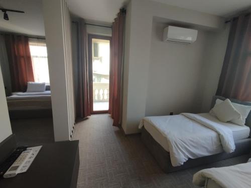 a hotel room with two beds and a window at Dastan Hotel Baku in Baku
