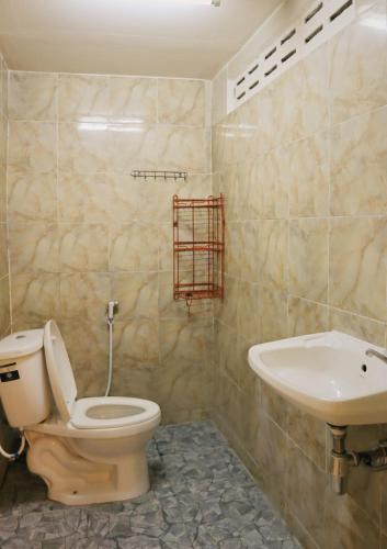 a bathroom with a toilet and a sink at Holy Hostel Sathorn in Thung Maha Mek