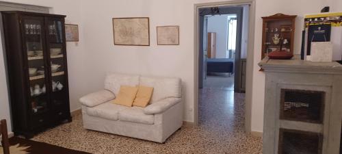 a living room with a chair and a fireplace at Atina House - Centro Storico in Atina