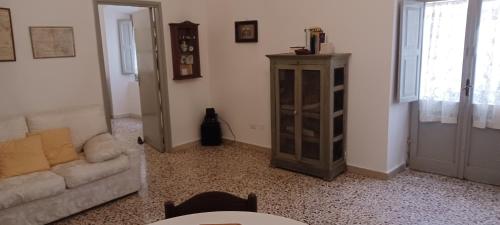 a living room with a couch and a cabinet at Atina House - Centro Storico in Atina