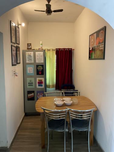 a dining room with a wooden table and chairs at Tehri Tales - Homestay on Char Dham Yatra Route in Chamba