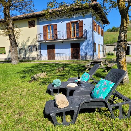 a table and chairs in front of a house at Villa Glory Mountain Lake Iseo Hospitality in Bossico
