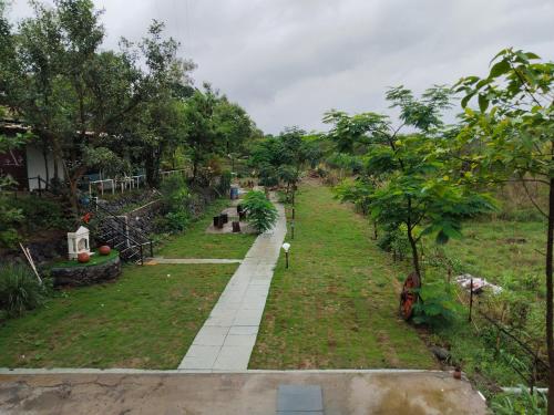 a view of a garden with a walkway at The Wai Hills MTDC Approved in Wai