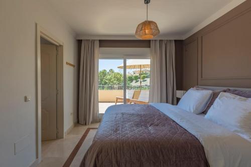 a bedroom with a large bed and a balcony at Casa Estelle - cozy with lovely garden - Mijas - Riviera del Sol in Mijas Costa