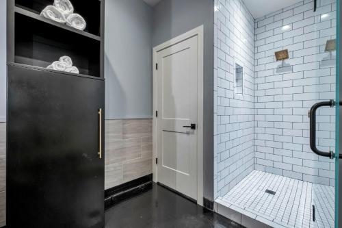 a bathroom with a shower with a black door at Modern Suite 6BR by Maddox Hotel in Nashville