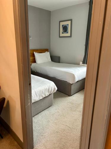 two beds in a room with two beds sidx sidx sidx at The Valley Hotel, Anglesey in Valley